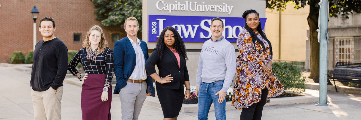 Law School Students in front of the sign